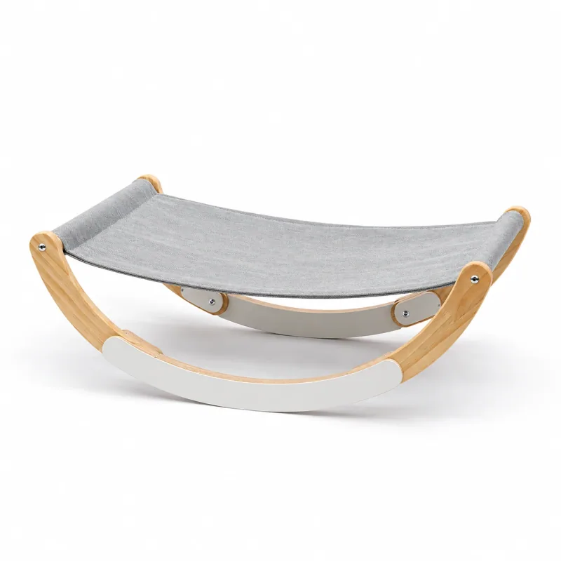 Empty gray sling hammock on a curved wooden frame.