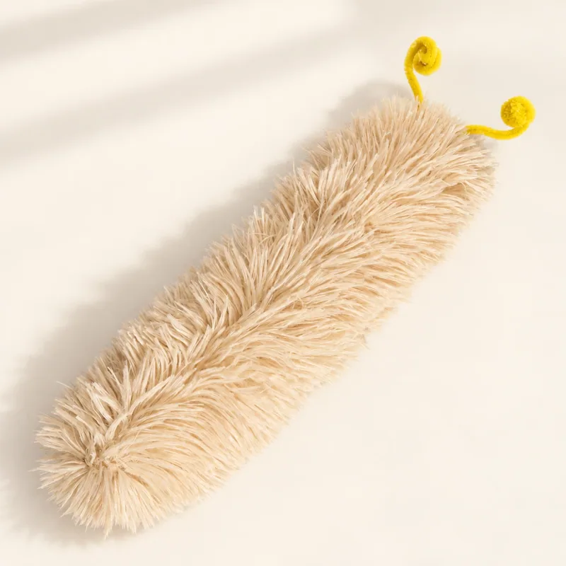 Long beige plush caterpillar toy with two yellow curled antennae
