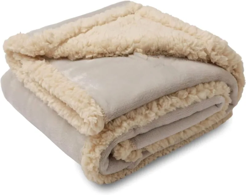 A folded beige pet blanket with a smooth face and contrasting cream plush reverse.